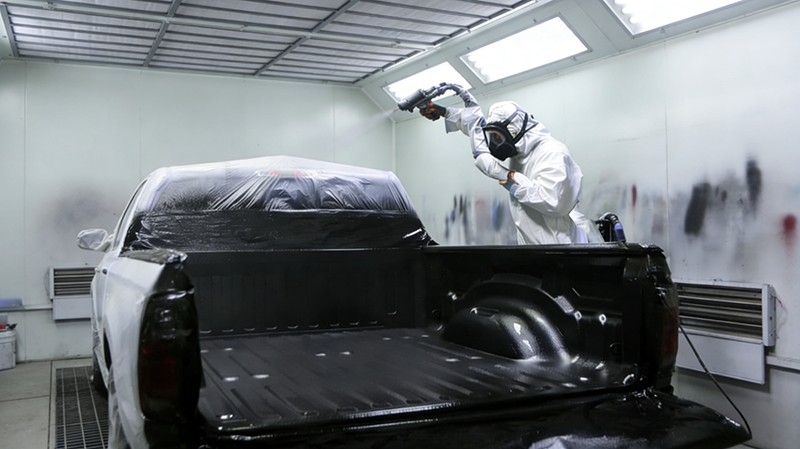 Spray polyurea coating applied on truck bed liner for impact and abrasion protection